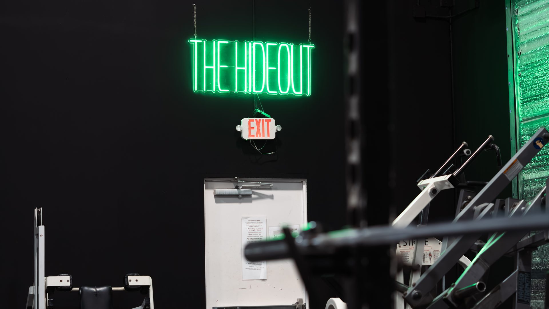 The Hideout neon sign inside Species Gym Katy